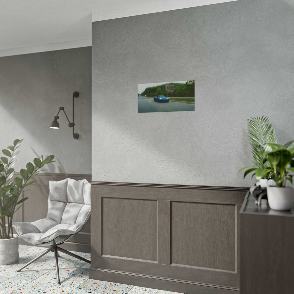 C8 Corvette Stingray blue sports car photo print on wall in modern room with gray chair and plants