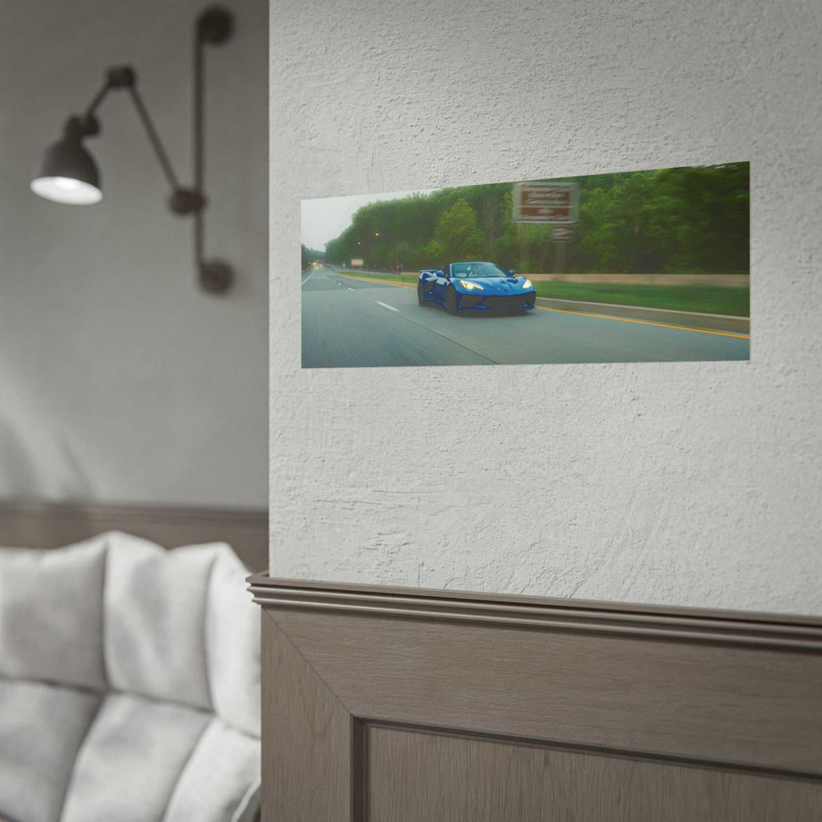C8 Corvette Stingray in blue driving on a tree-lined highway with motion blur effect and clear detail print
