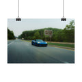 C8 Corvette Stingray blue sports car driving fast on a tree-lined highway with motion blur capturing speed