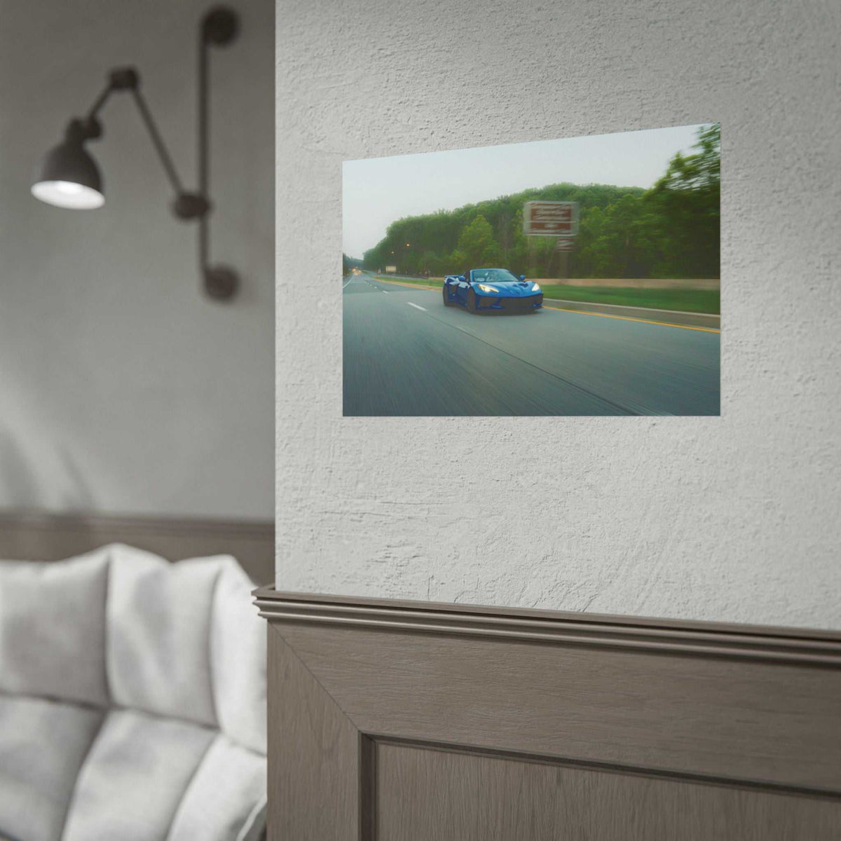 C8 Corvette Stingray blue sports car on highway with motion blur and tree-lined background in photographic print