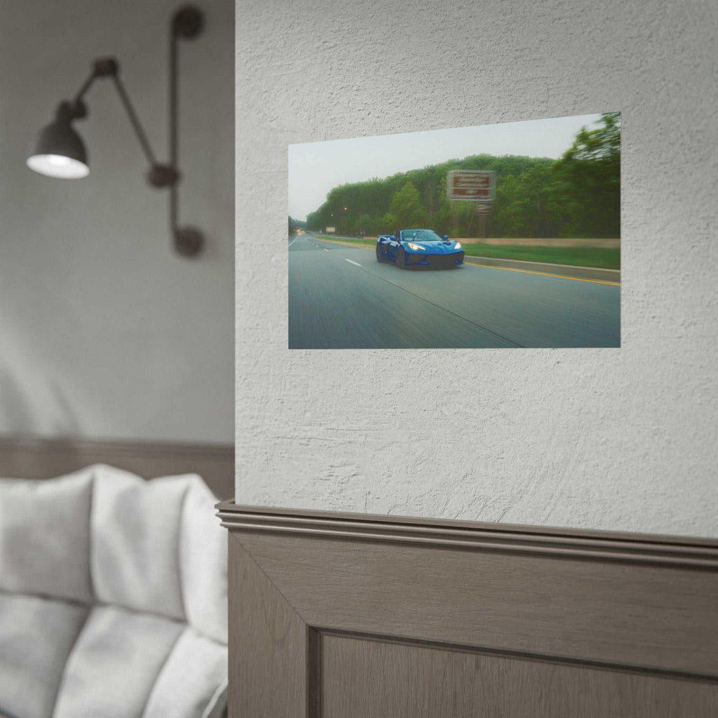 C8 Corvette Stingray blue sports car speeding on tree-lined highway with motion blur in a photographic print on textured wall