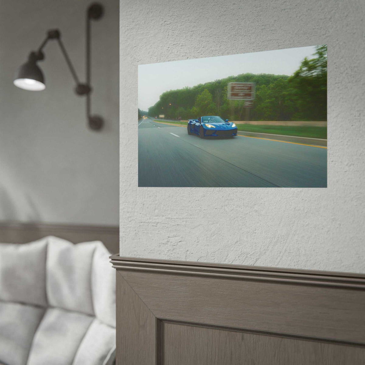 C8 Corvette Stingray blue sports car print on textured wall showing motion blur on tree-lined highway