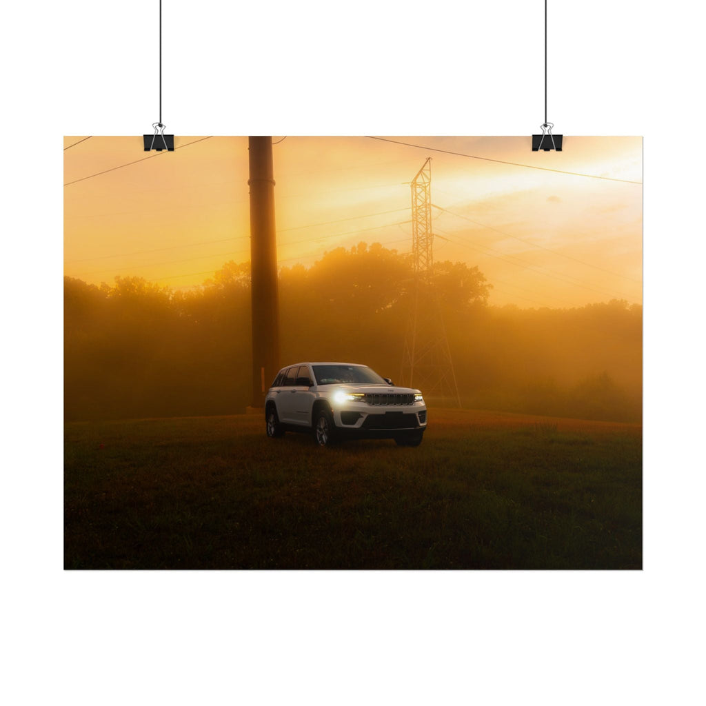 Jeep Grand Cherokee in white driving through warm, hazy amber sunset fog with power lines and trees in background