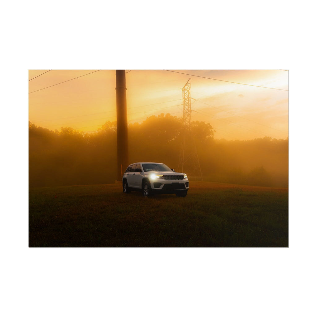 Jeep Grand Cherokee white SUV with headlights on cutting through warm, hazy sunset fog and grassy terrain