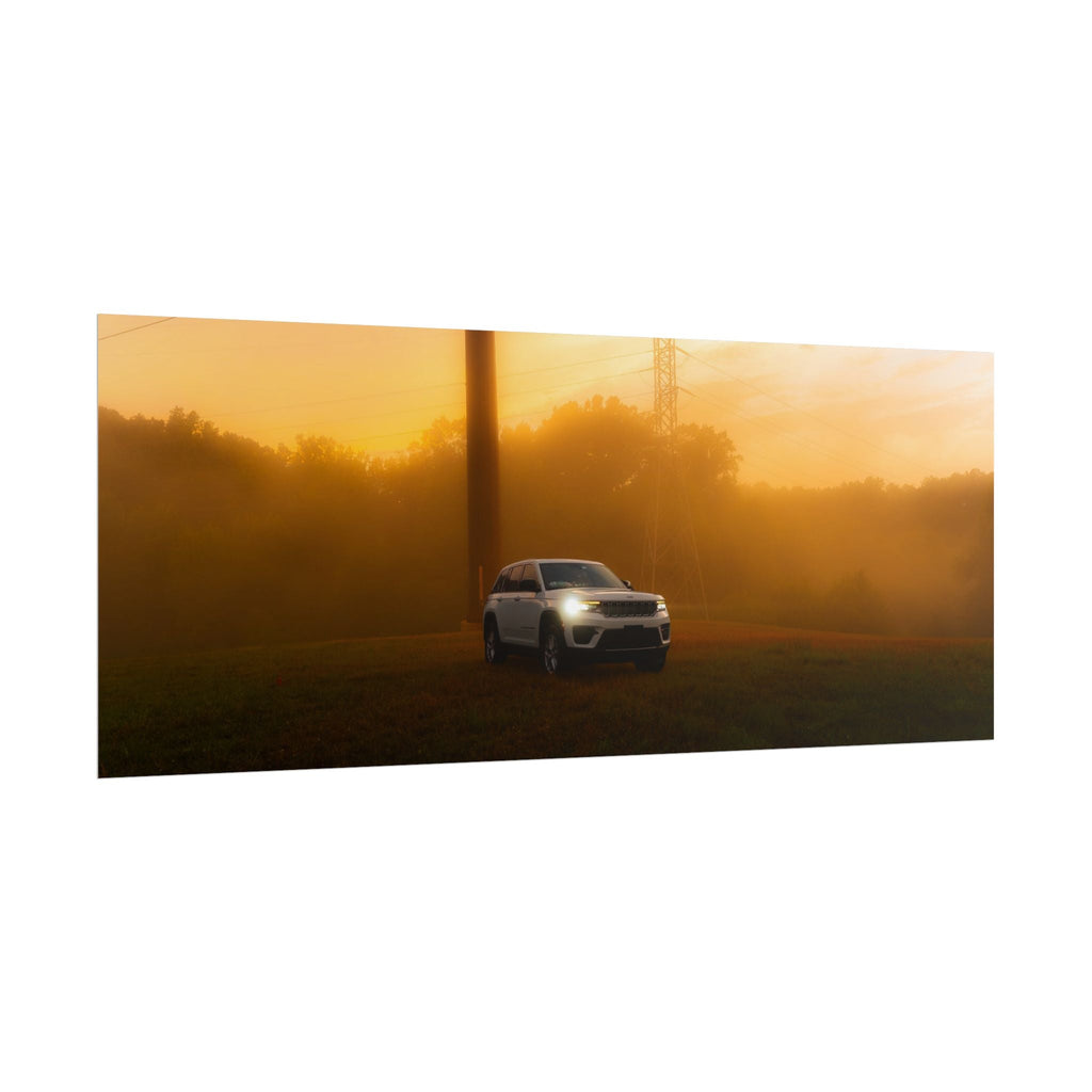 Jeep Grand Cherokee white SUV cutting through warm, hazy amber sunset fog with headlights on and power lines visible