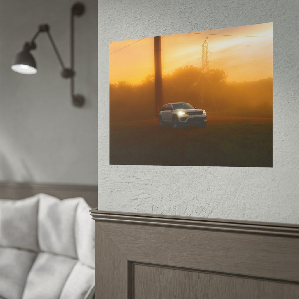 Jeep Grand Cherokee white SUV with headlights on driving through warm amber sunset fog with power lines in background